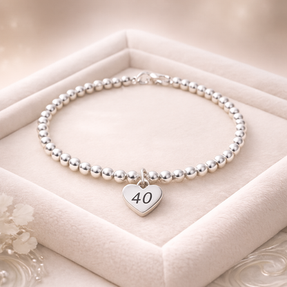 Milestone 40 keepsake bracelet displayed on a soft velvet background