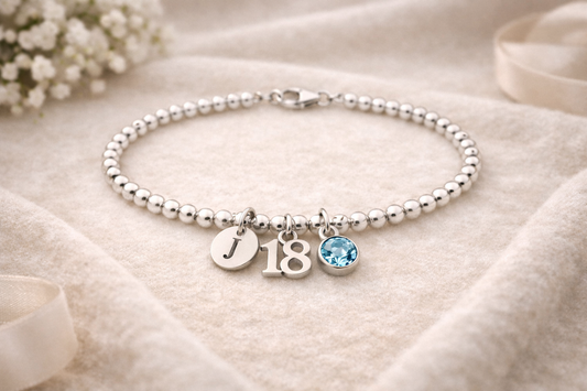 silver 18th birthday bracelet with personalised initial charm